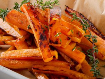 Golden sweet potato fries cooling from the oven