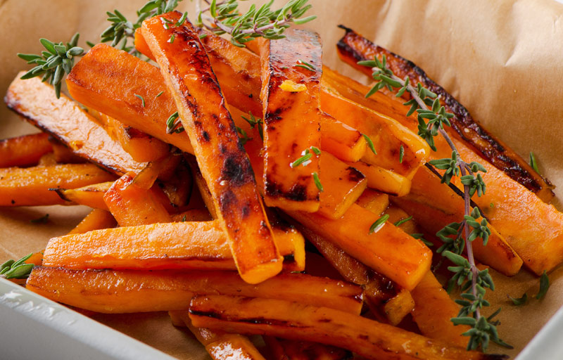 Golden sweet potato fries cooling from the oven
