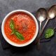 Delicious tomato soup in a white bowl with fresh parsley on top