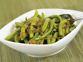 Tasty green beans steamed to pefection is a white bowl