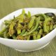 Tasty green beans steamed to pefection is a white bowl