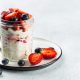 Tasty-looking overnight oats in a cup with straberries and blueberries