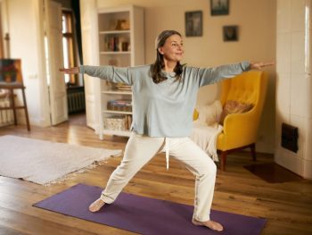 Woman doing a yoga pose as she eases back into exercises after her hysterectomy