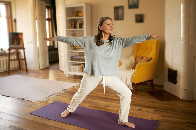 Woman doing a yoga pose as she eases back into exercises after her hysterectomy
