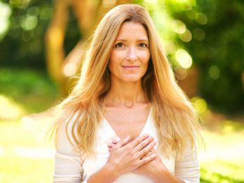 Grateful woman placing her hands on her heart in gratitude