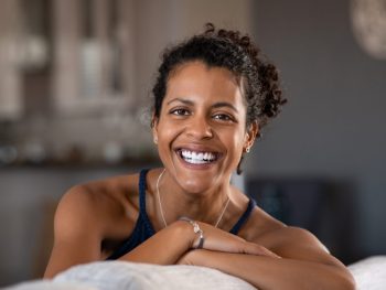 Woman smiles as she looks into the camera, optimistic about life after hysterectomy