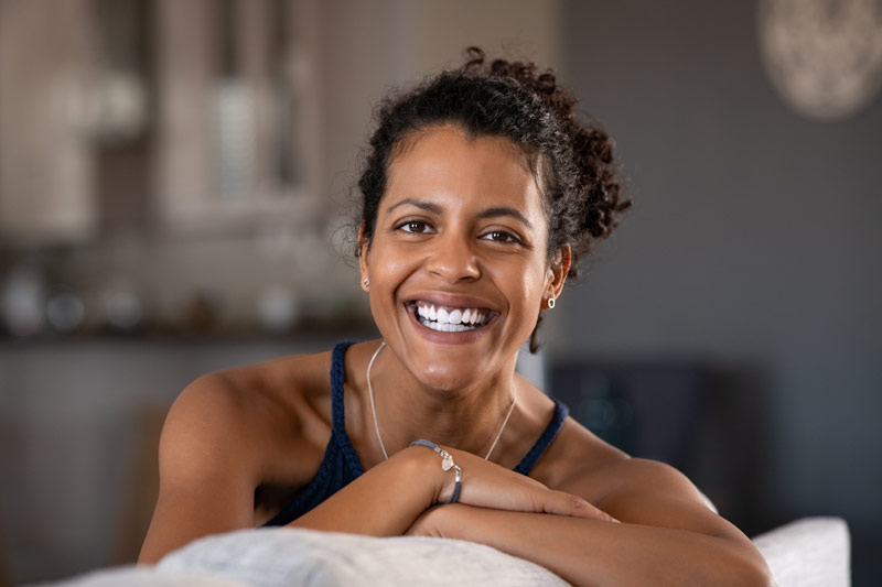 Woman smiles as she looks into the camera, optimistic about life after hysterectomy