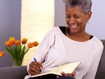 Woman smiles as she journals