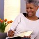 Woman smiles as she journals