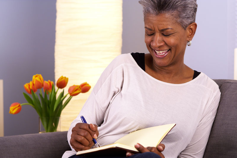Woman smiles as she journals