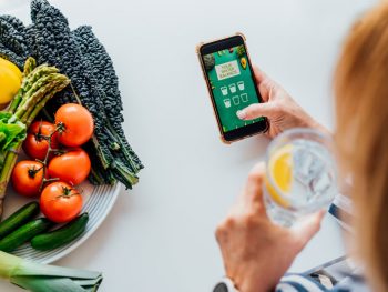 Woman loading app to track her water and calorie intake post-hysterectomy