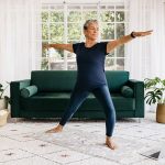 Woman in warrior post, using strength training to combat weight gain during menopause after hysterectomy