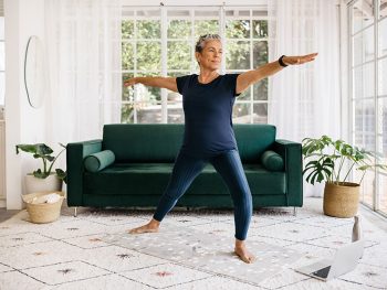 Woman in warrior post, using strength training to combat weight gain during menopause after hysterectomy